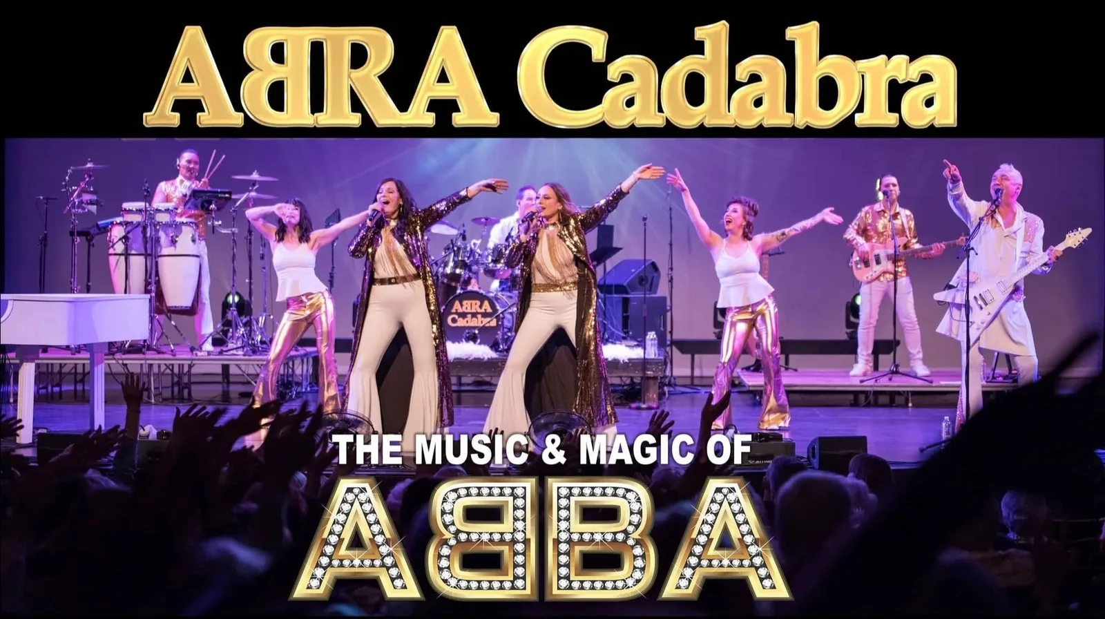 ABRA Cadabra on a purple-lit stage, four singers in gold and white flares with the band behind them, between gold lettering that reads ABRA Cadabra above and The Music & Magic of ABBA below.